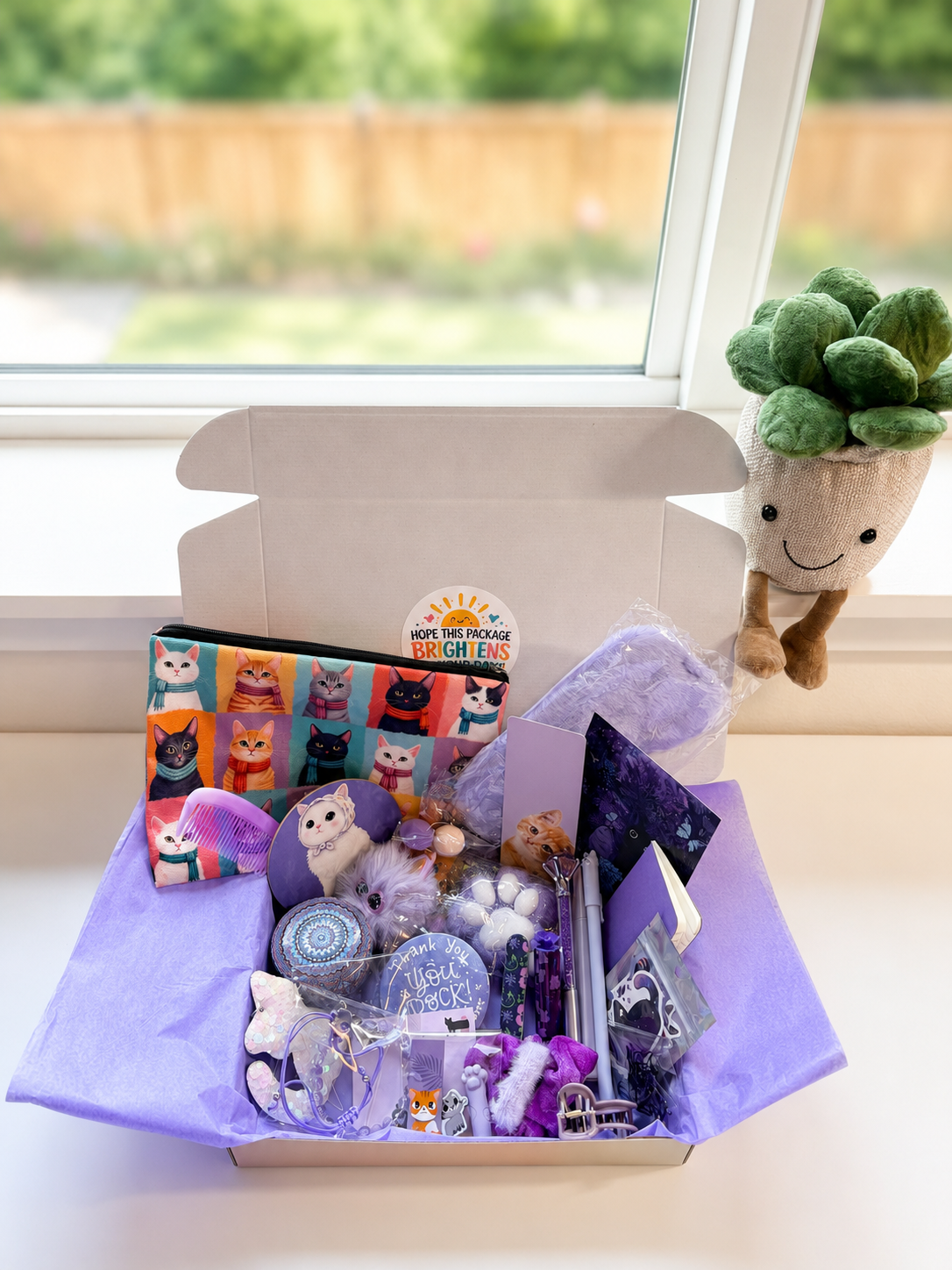 open cat gift box showing stationery accessories and cozy cat items